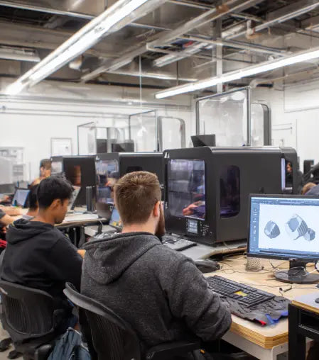 Engineers using CAD software and professional 3D printers for product development, rapid prototyping and additive manufacturing
